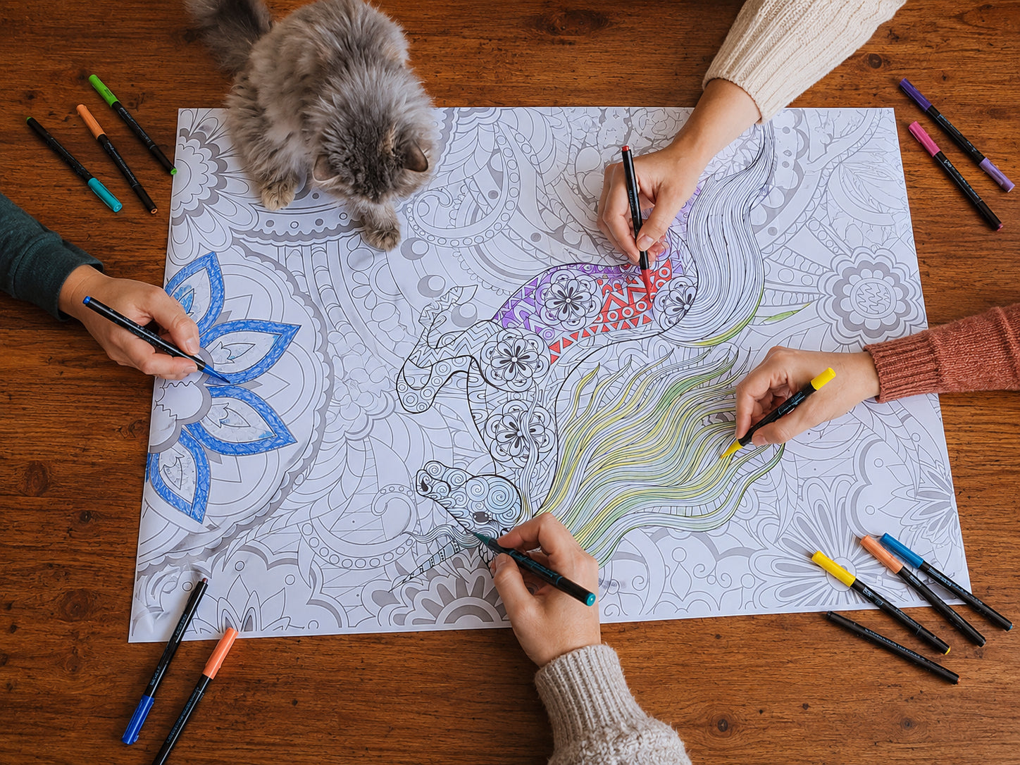 Group of adults coloring a giant poster together around a table during a therapy session